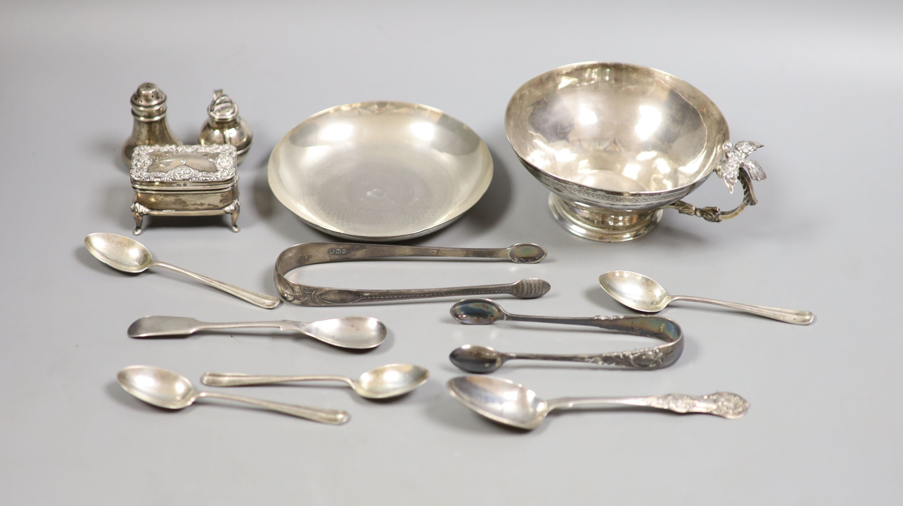 A Persian white metal tea cup and saucer and small sile items including two pepperettes, a trinket box and assorted minor flatware